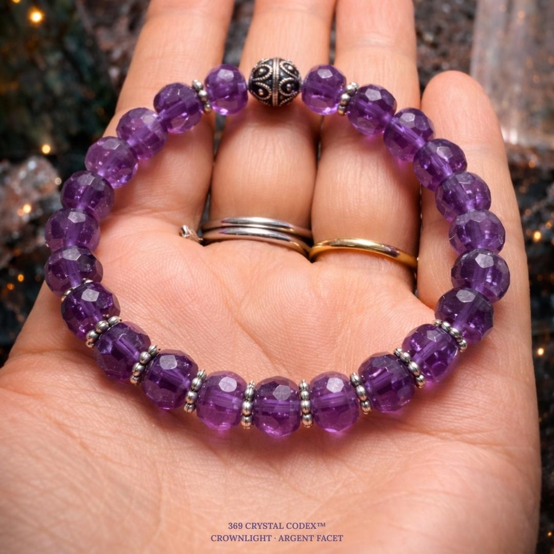 Amethyst bead bracelet held in a hand.