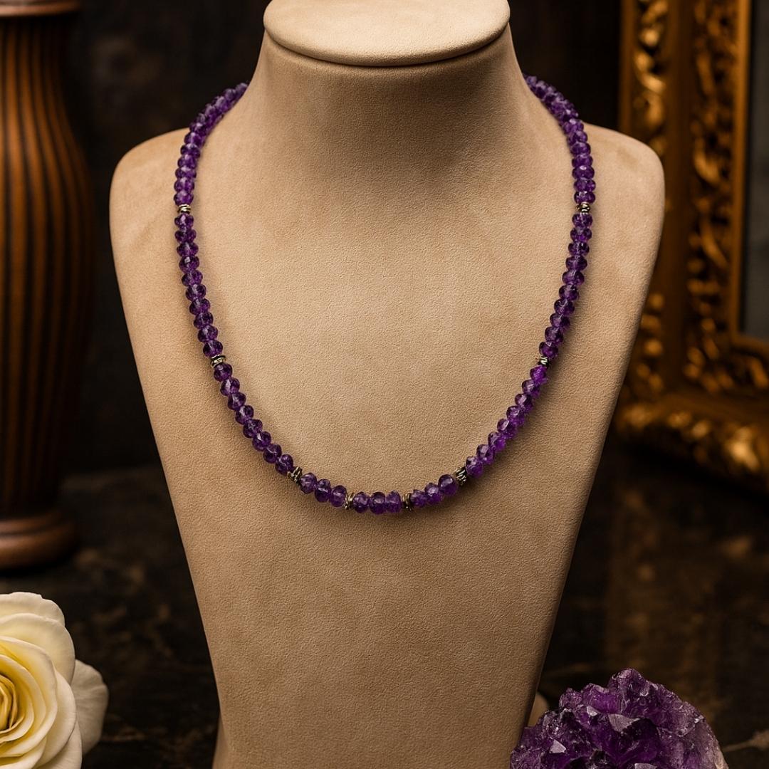 Amethyst bead necklace on a jewelry display.