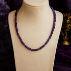 Amethyst bead necklace on a jewelry display.