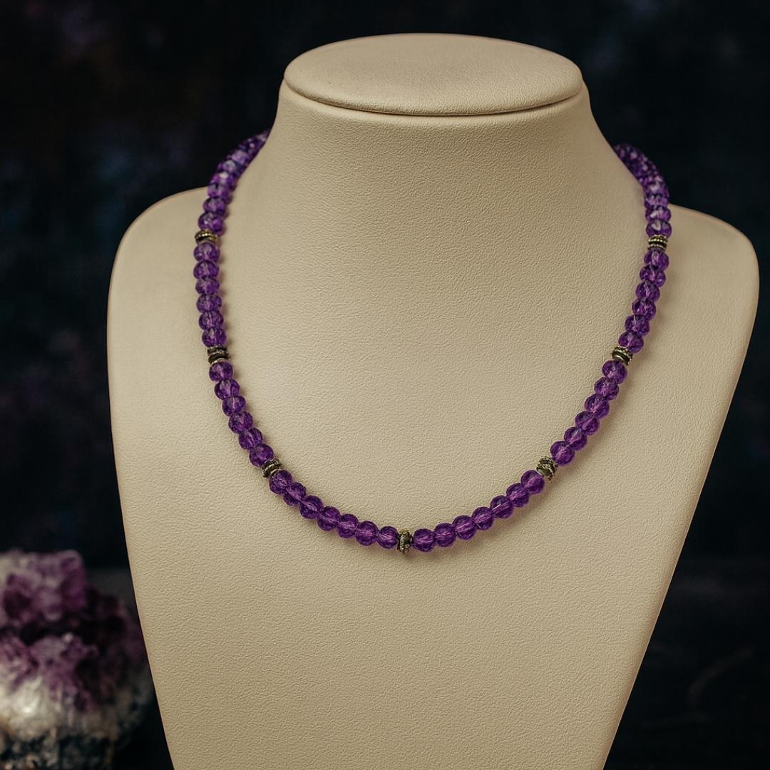 Amethyst bead necklace on a jewelry display.