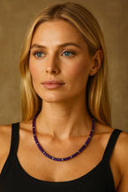 Amethyst bead necklace worn around the neck.