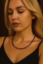 Amethyst bead necklace worn around the neck.