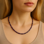 Amethyst bead necklace worn around the neck.
