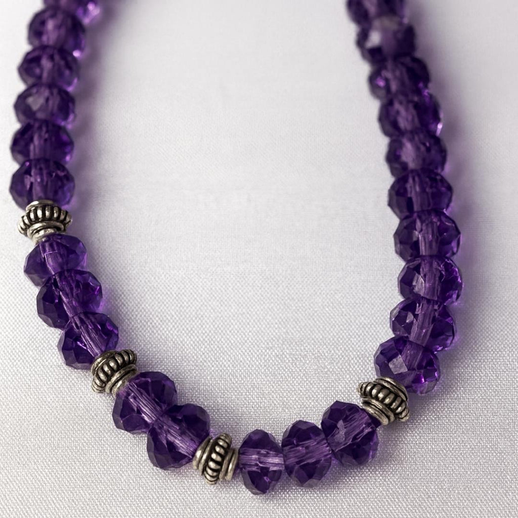 Close-up of amethyst bead necklace.