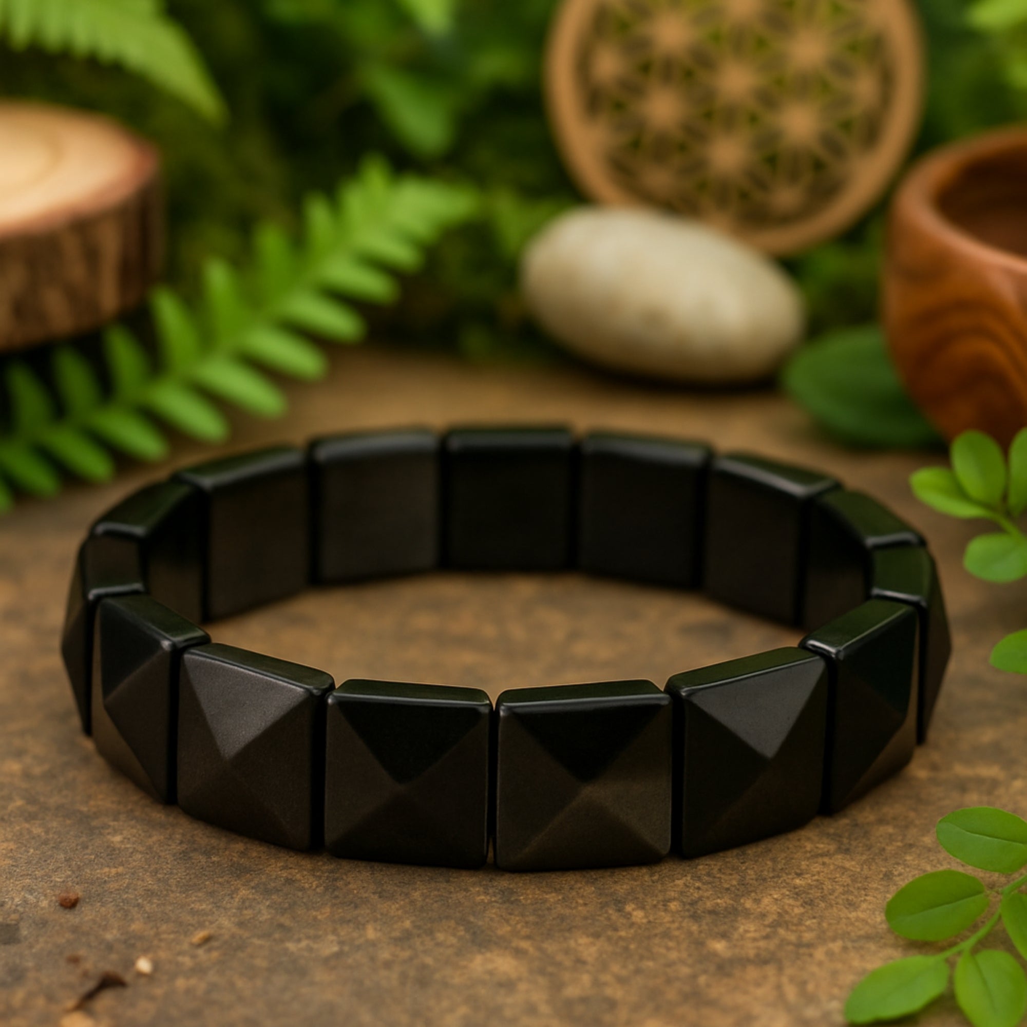 Obsidian Core Bracelet flat lay on wood — each square pyramid bead cut to precision at 12x12mm from natural Silver Obsidian. Wearable talisman for clarity, protection, and inner focus. Handmade luxury crystal bracelet, spiritual grounding jewelry, unique gift for meditation lovers. Black obsidian gemstone bracelet for him or her.
