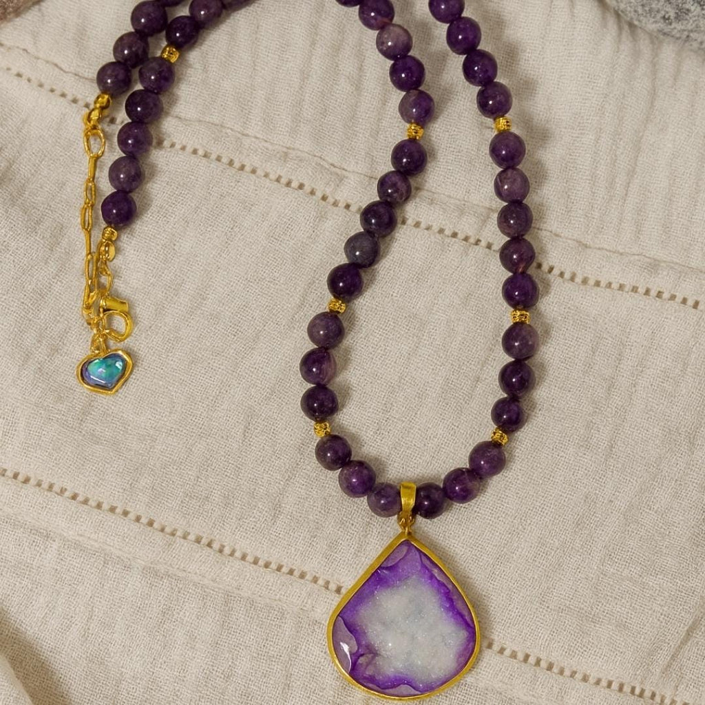 Buy this 8mm Amethyst Druzy Necklace to enhance your psychic abilities and spiritual vision. Shop this 18K Gold Plated Shield to ward off stress and bad vibes. Order this Luxury Gemstone Jewelry as a meaningful Graduation Gift or Self Care treat. Get this Prosperity Crystal to attract abundance and mental focus. Choose this Crown Chakra stone for divine connection. Purchase this Elegant Necklace for a gala. Select this Flashy Druzy for its unique copper glow.